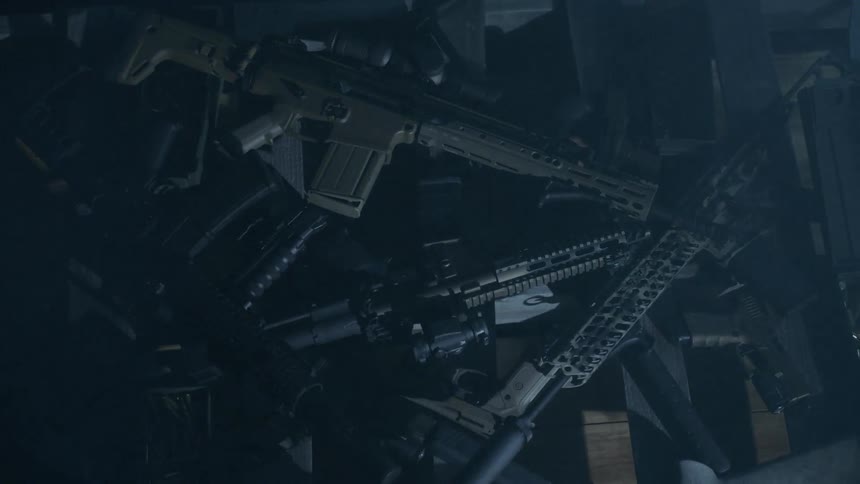 A light passes over guns sitting on a table