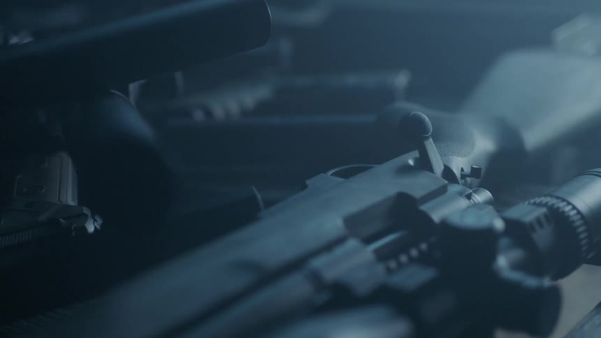 Firearms in a pile on a table
