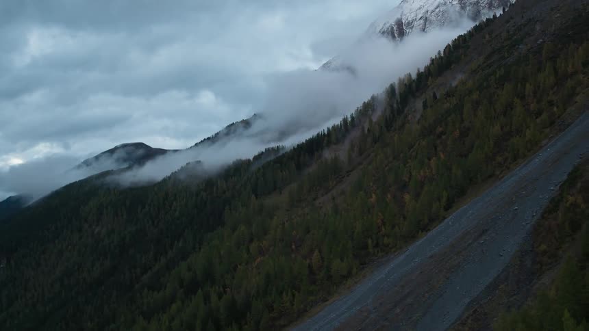 Thick fog rolls down a mountain