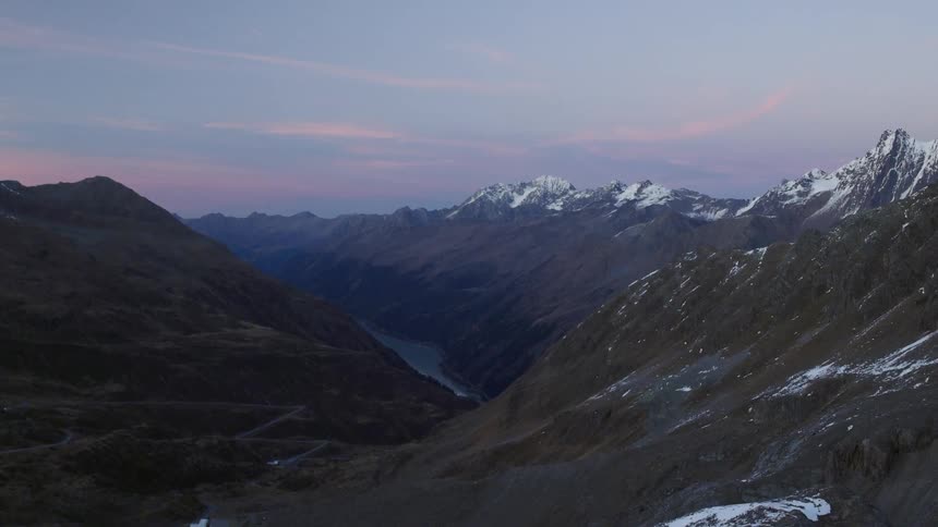River running through snow capped mountain range