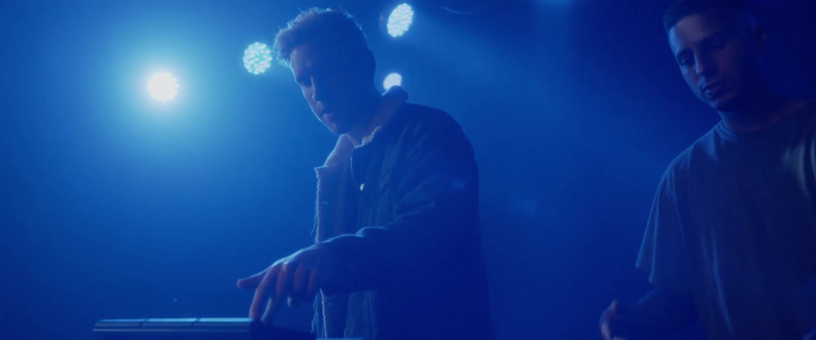 Musicians perform on a lit stage