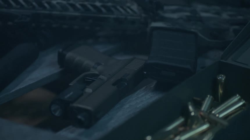 Guns and ammo sit on a table