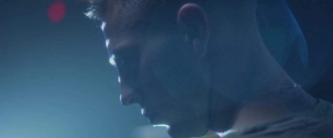 Lights shine on a man's face