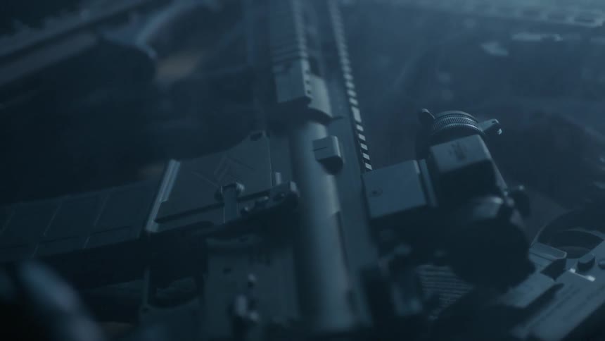 Pile of firearms on a desk