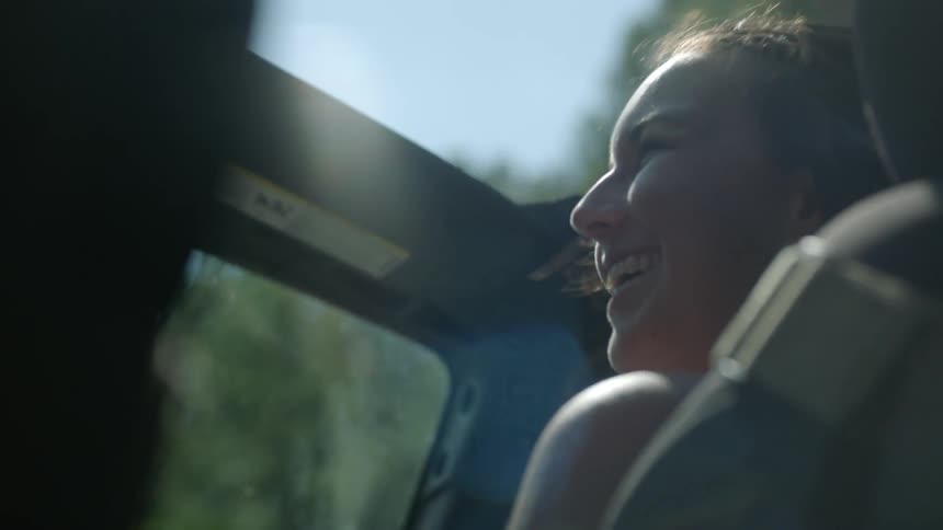 Smiling woman rides in a jeep