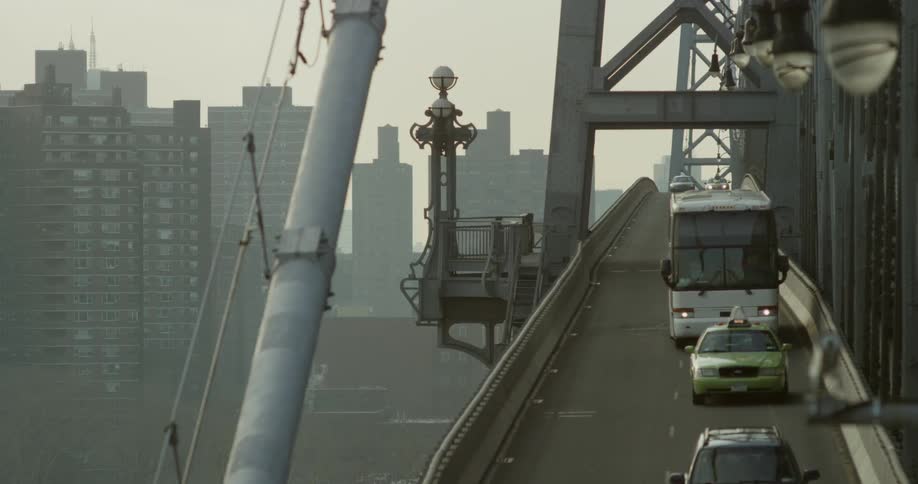 Cars traveling with buildings behind them