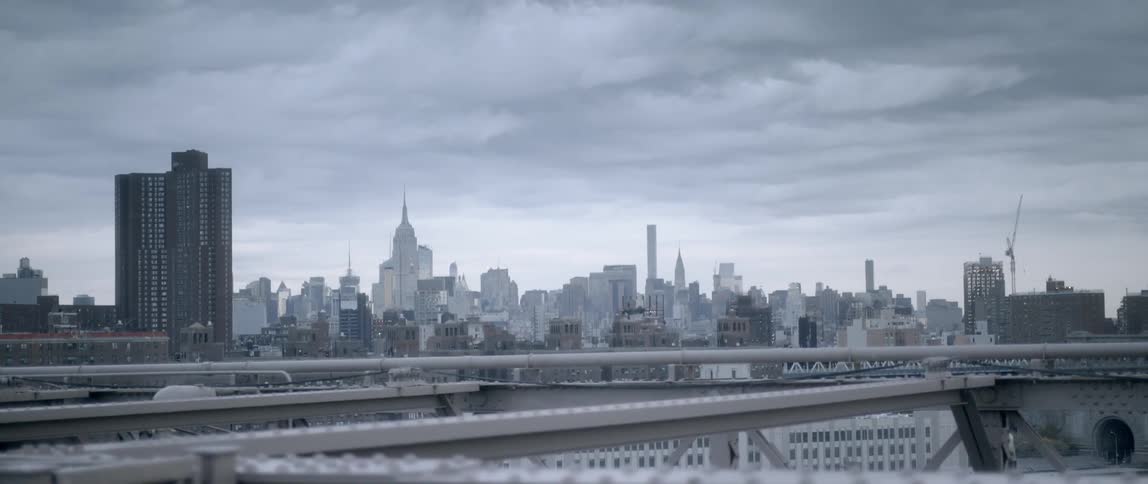 Clouds float above city skyscrapers