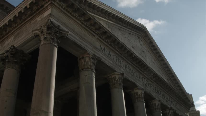 The tall building has pillars surrounding it