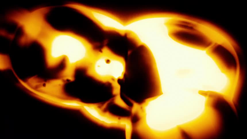 Golden orbs glow and pulsate as dark, ink-like liquid moves inside them