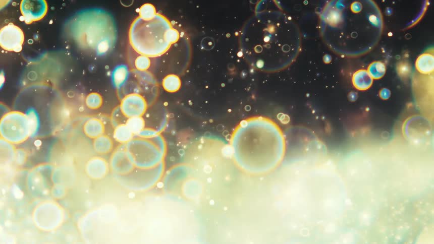 Magical glowing orbs and celestial particles drift and float in a mesmerizing abstract animation