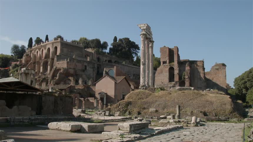 Ancient ruins stand against a bright blue sky