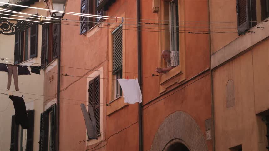 Laundry hanging on a line outside an apartment building
