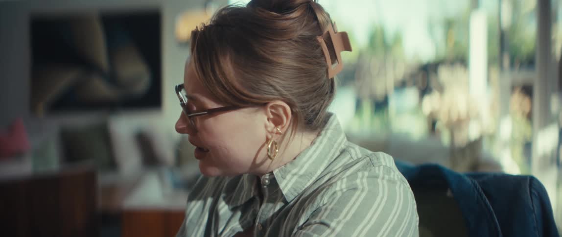 An adult daughter gently holds her senior mother's hands, offering comfort and support during a heartfelt conversation at home