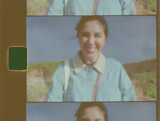 Nostalgic Super 8mm film strip captures a young woman smiling and waving while on a nature hike