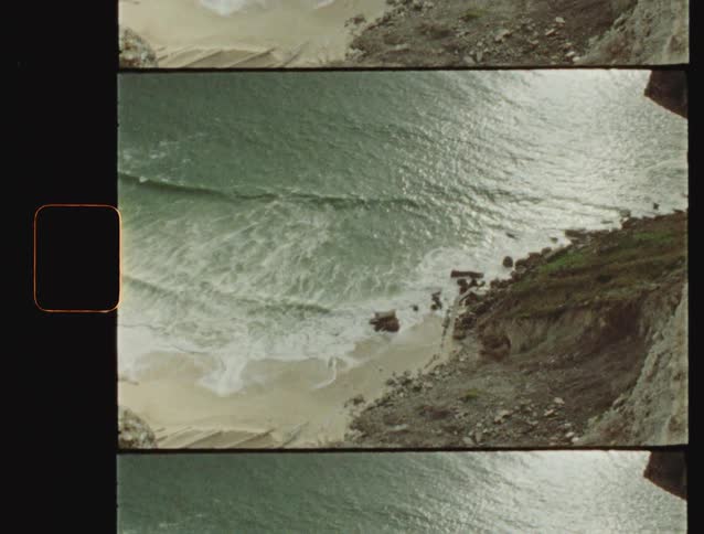 High angle view of waves crashing on a secluded beach with a vintage film look
