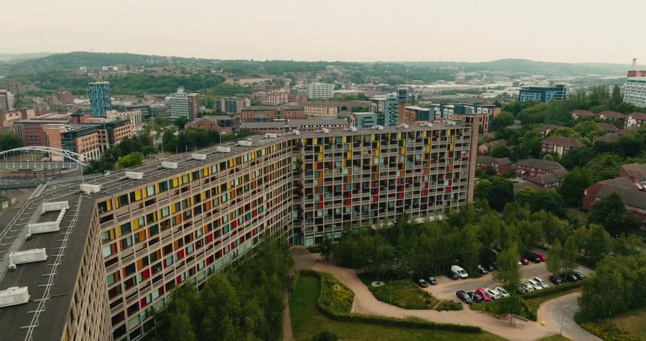 Slowly rising aerial footage captures the iconic brutalist architecture of the Park Hill council estate in Sheffield, UK