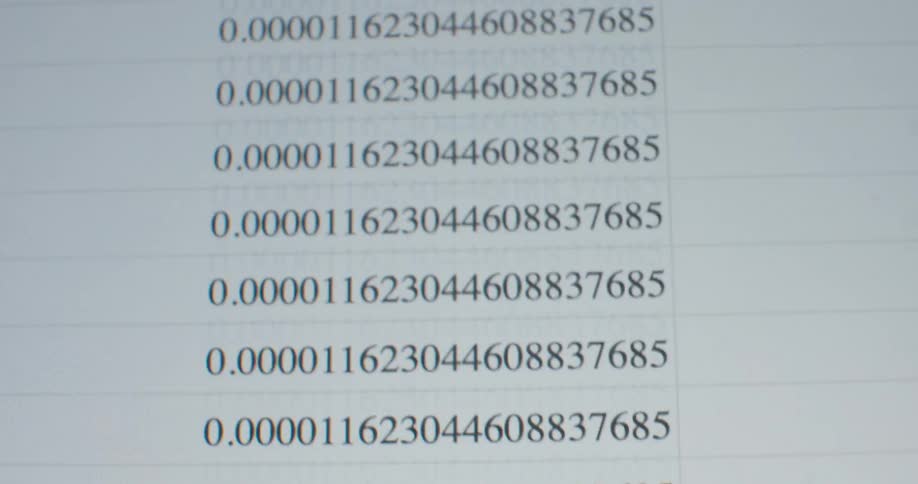A macro shot shows a computer screen with repeating decimal numbers scrolling quickly on a data sheet