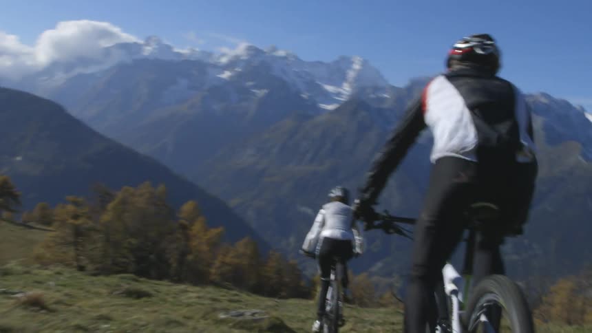 Two people mountain biking