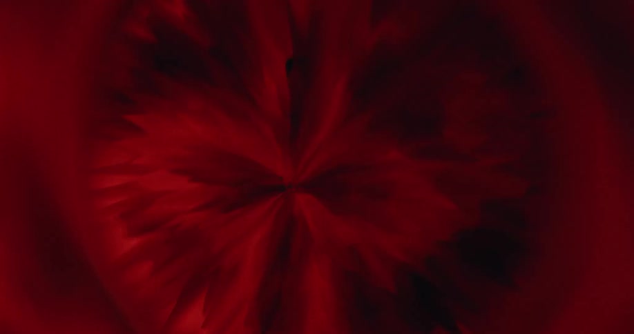 A hypnotic macro view of abstract red and orange crystal formations expanding and pulsing with light
