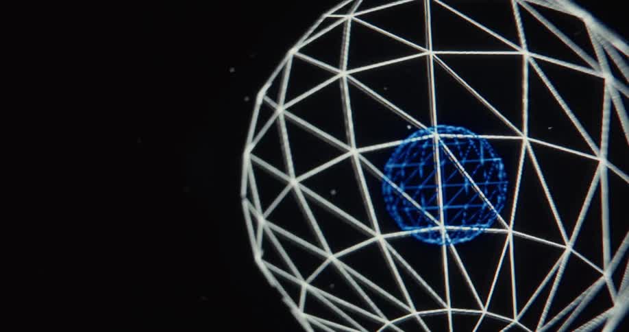 A retro computer-generated animation shows a blue wireframe sphere floating inside a larger white wireframe sphere