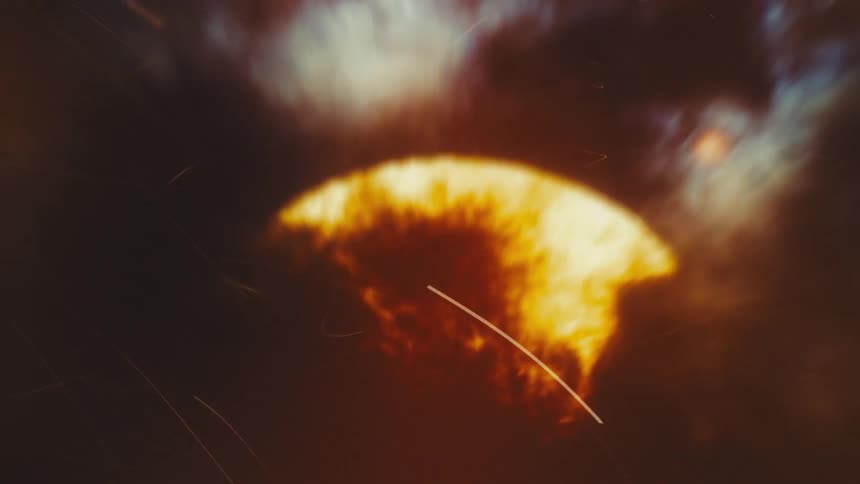 An abstract, fiery explosion pulses with chaotic energy amidst dark clouds and flying sparks