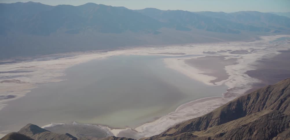 A vast and serene high-angle view of the salt flats and basin of Death Valley National Park