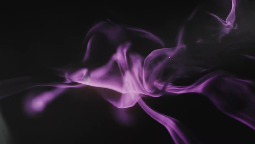 Vibrant purple smoke swirls gracefully in slow motion against a dark, mysterious background
