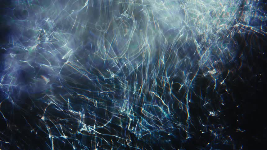 Cosmic and ethereal web of shimmering blue light weaves intricate patterns with soft bokeh highlights