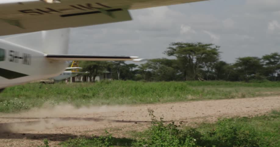 Small airplane landing in a field