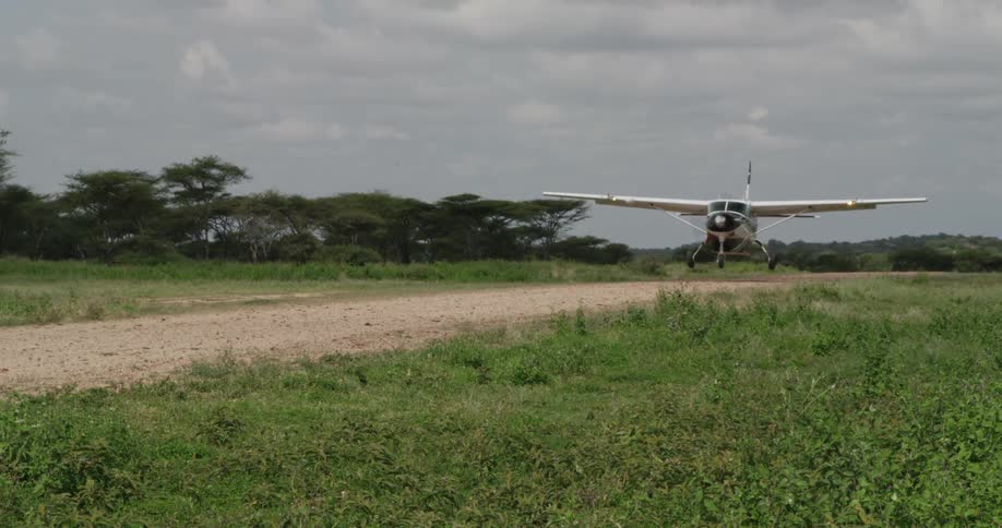 A small airplane taking off from a field