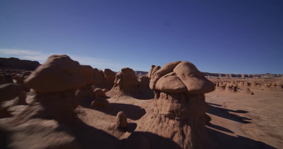 An immersive point-of-view shot glides through the alien-like landscape of Goblin Valley State Park in Utah
