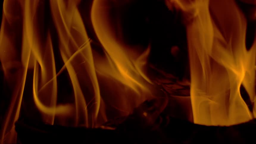 Hypnotic slow-motion flames dance elegantly against a solid black background
