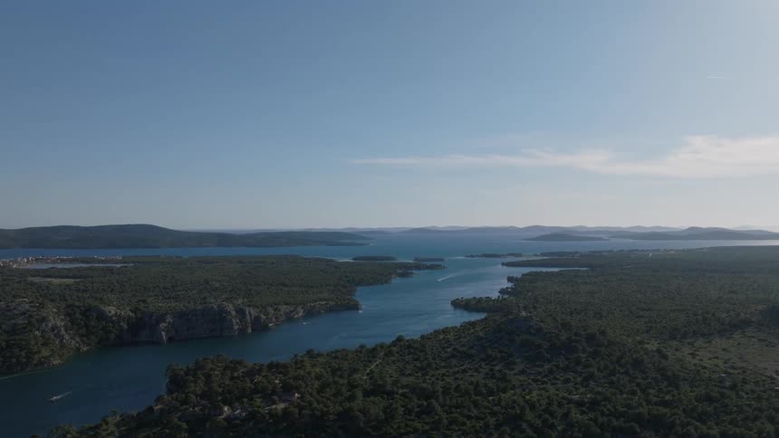 A stunning high-angle view of the St. Anthony Channel in Croatia as it flows majestically through a verdant landscape towards the Adriatic Sea