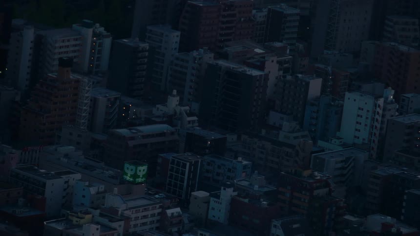 A slow zoom-out reveals a vast, dense urban landscape at twilight, with buildings fading into the blue darkness