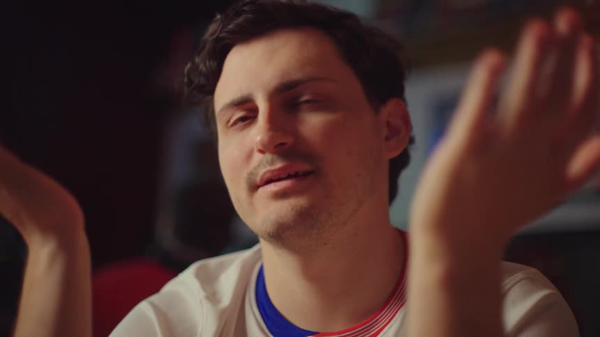 A devoted sports fan experiences a rollercoaster of emotions, from tense hope to eventual disappointment, while watching a game