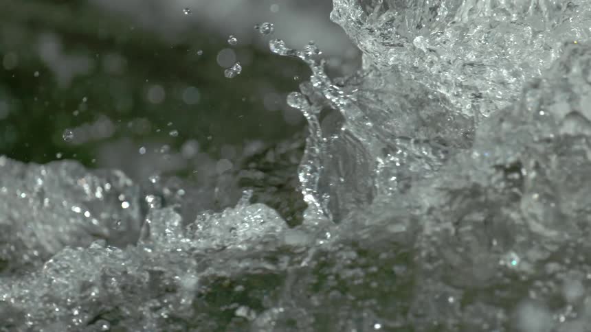 A mesmerizing extreme close-up of churning water as it splashes and glistens in super slow motion