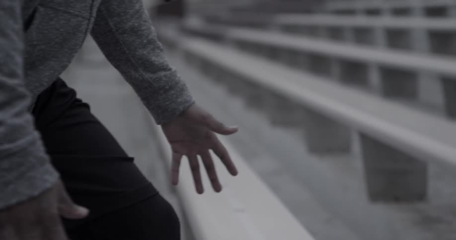 Man prepares to run up metal bleachers