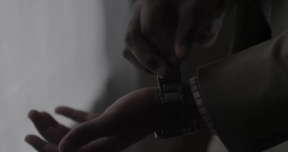 A man puts on a watch