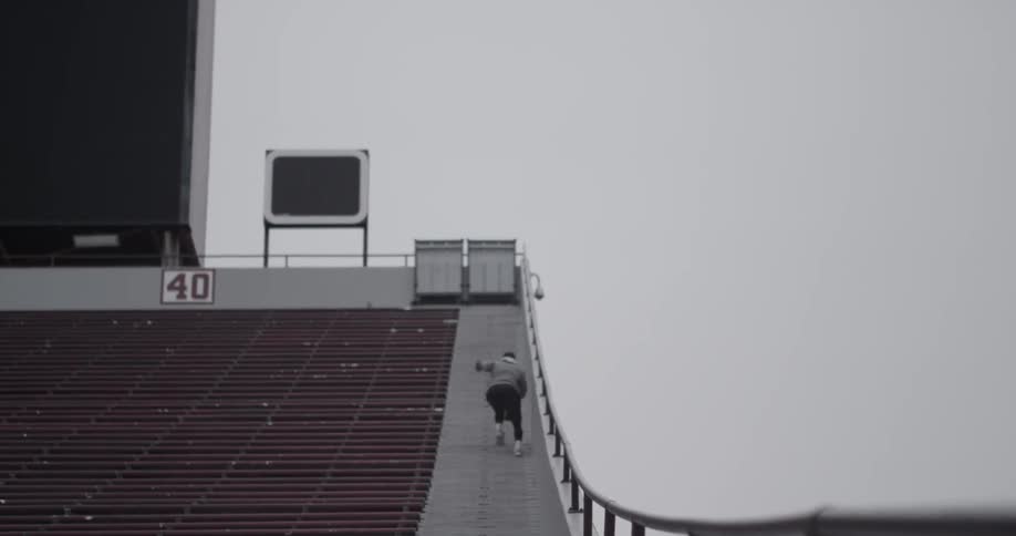 Man sprints up stairs of a bleacher