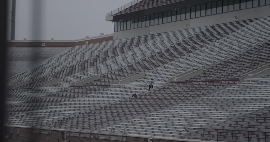 A man sprinting up stadium steps