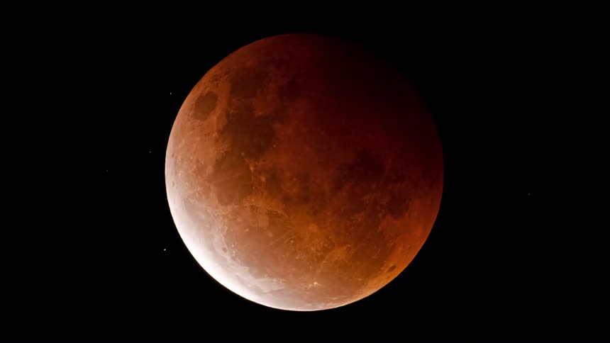 A dramatic time-lapse of a total lunar eclipse reveals the transition from a full moon to a stunning red blood moon and back again