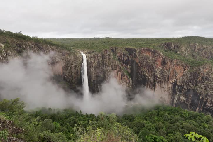 A breathtaking timelapse shows mist swirling around a magnificent waterfall plunging into a deep, forested canyon