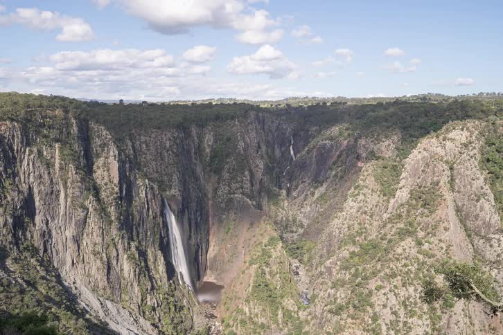 A stunning timelapse of cloud shadows sweeping across a majestic canyon and its towering waterfalls under a blue sky
