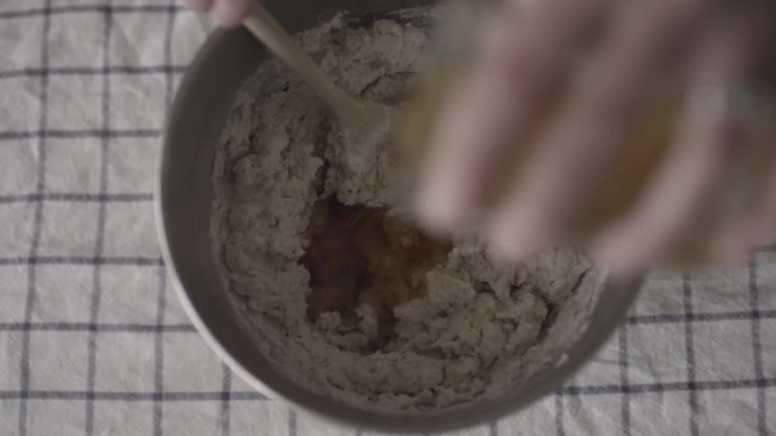 Woman adds ingredients to batter