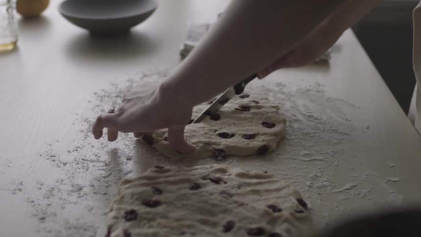 Person cuts raw cookie dough into wedges