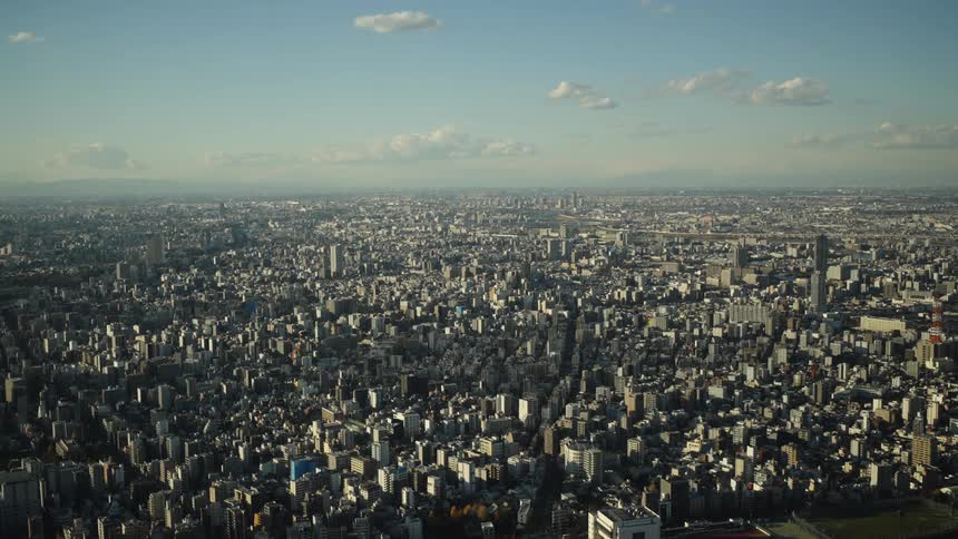 An expansive aerial view of the endless urban sprawl of Tokyo, Japan, on a clear day