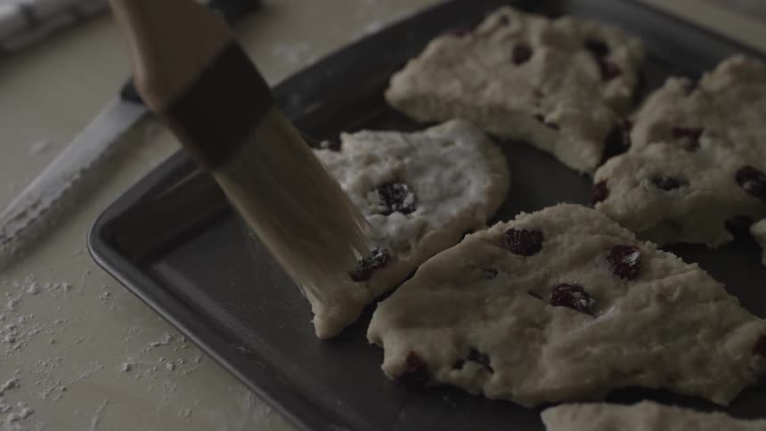 Brush scrapes across the top of raw cookie dough
