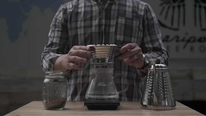 A person is making drip coffee