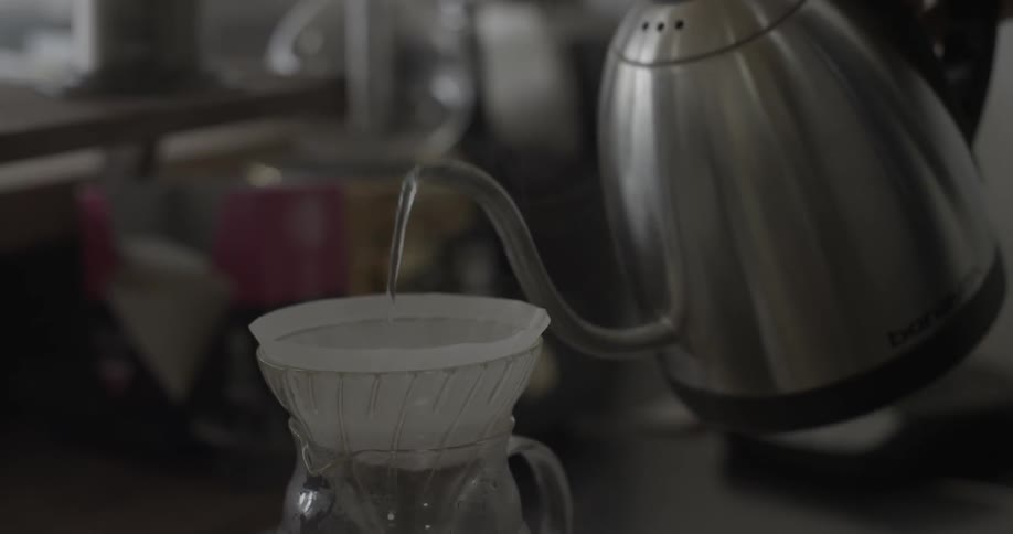 Liquid being poured from a kettle into a filter