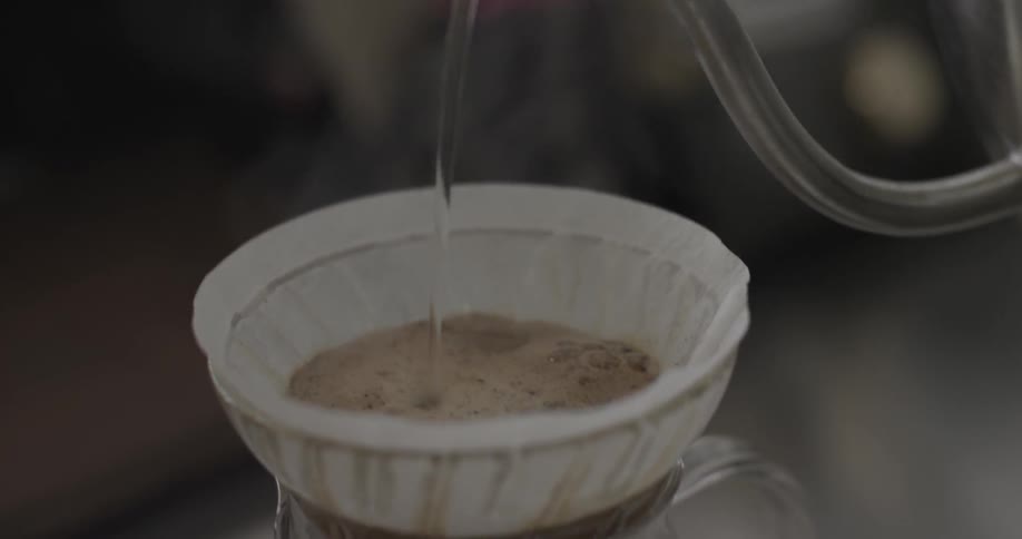 Steaming water is poured into a coffee filter